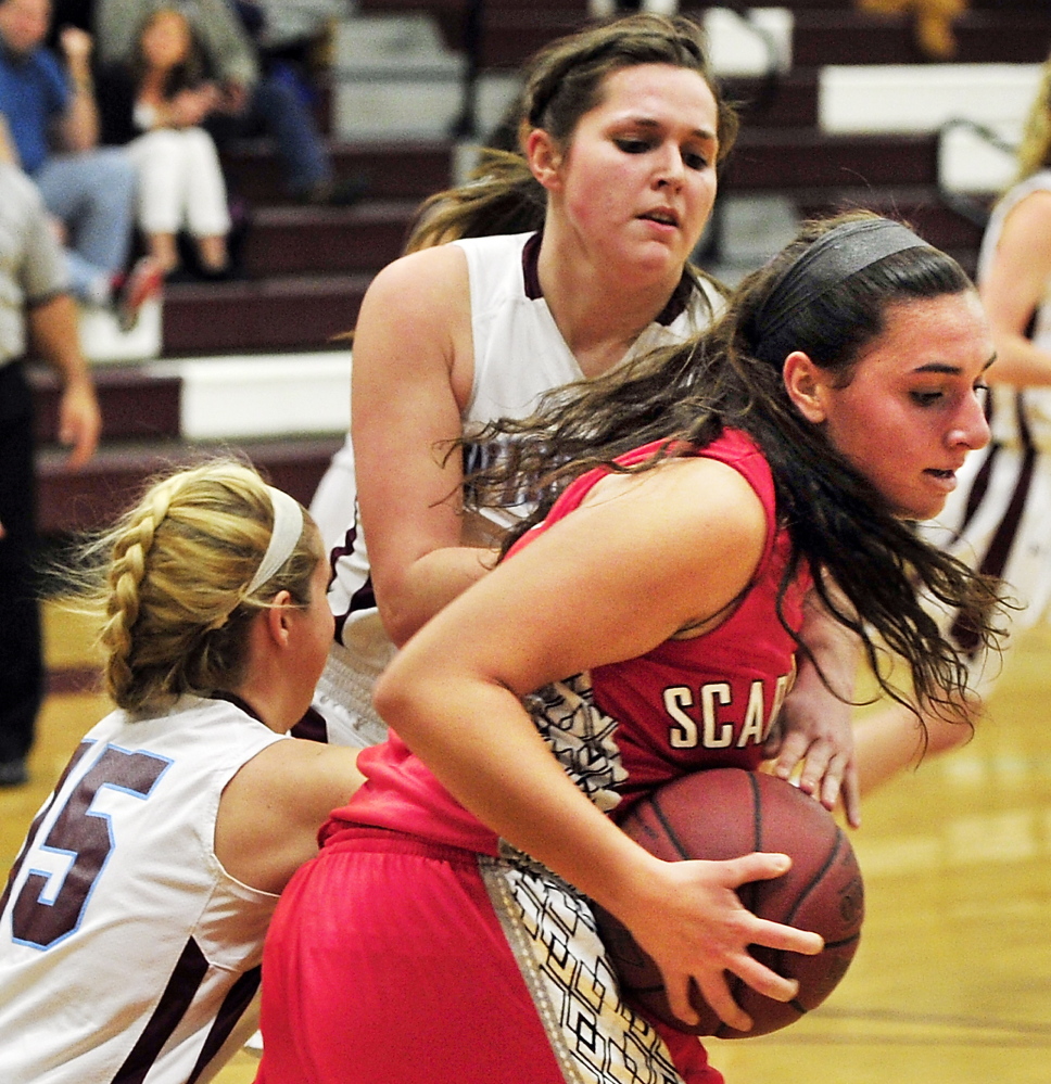 Emma Hall of Scarborough pulls down a rebound in front of Windham’s Macy Mannette, left, and Haley Batchelder. Windham handed the Red Storm their first loss.