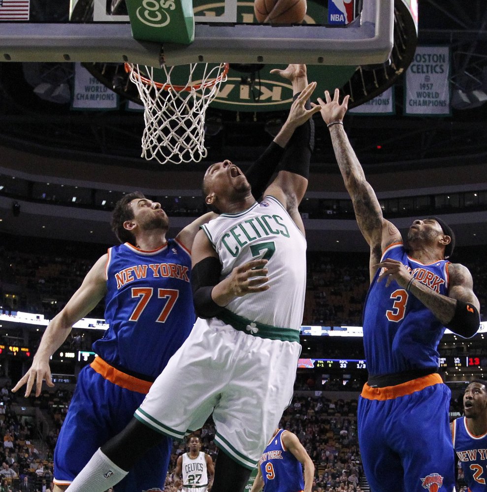 Boston’s Jared Sullinger battles New York’s Andrea Bargnani, left, and Kenyon Martin for a rebound in the first quarter of Friday’s game in Boston.