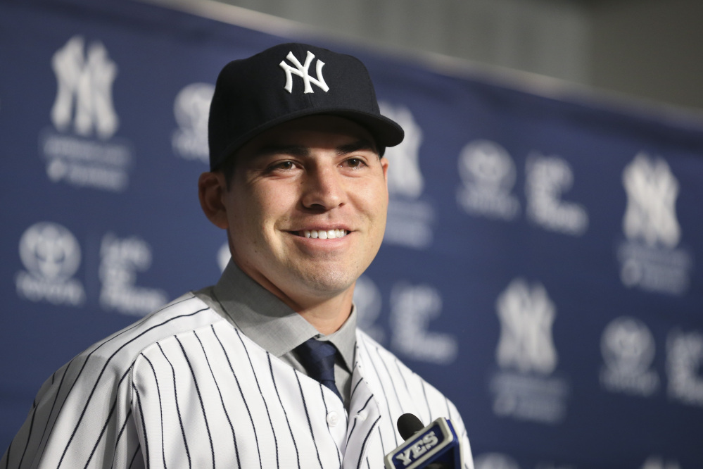 Jacoby Ellsbury smiles while taking questions during a news conference at Yankee Stadium on Friday in New York. The former Boston Red Sox outfielder agreed to a $153 million, seven-year contract with the Yankees.