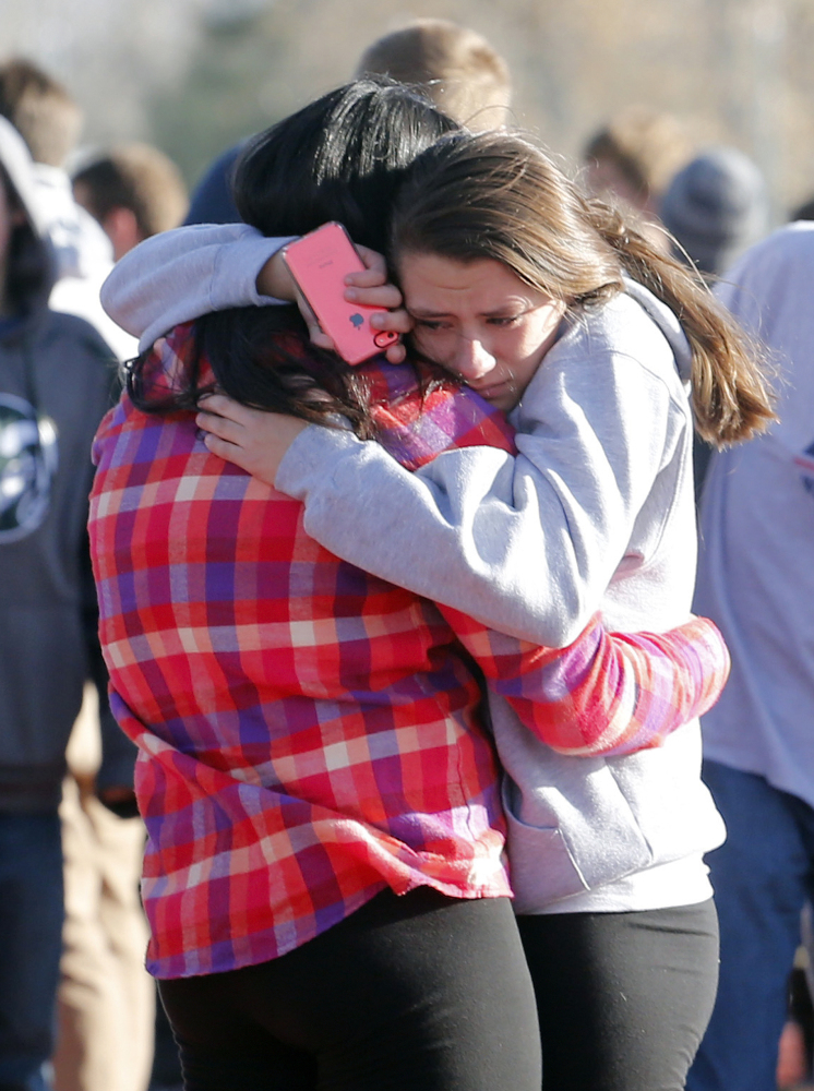 Students comfort each other outside of Arapahoe High School after a shooting on the campus in Centennial, Colo., on Friday. Arapahoe County Sheriff Grayson Robinson said the shooter wounded two students before killing himself.