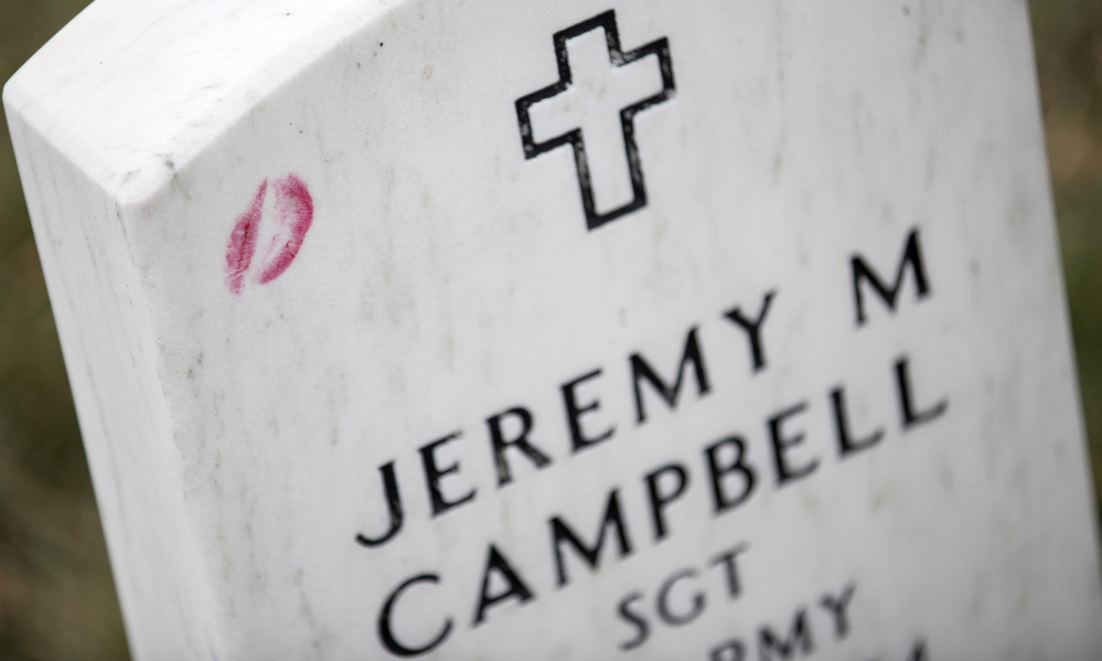A lipstick kiss rests on the gravestone of Jeremy M. Campbell in Section 60 at Arlington National Cemetery, the site of an annual Wreaths Across America event founded in Maine.