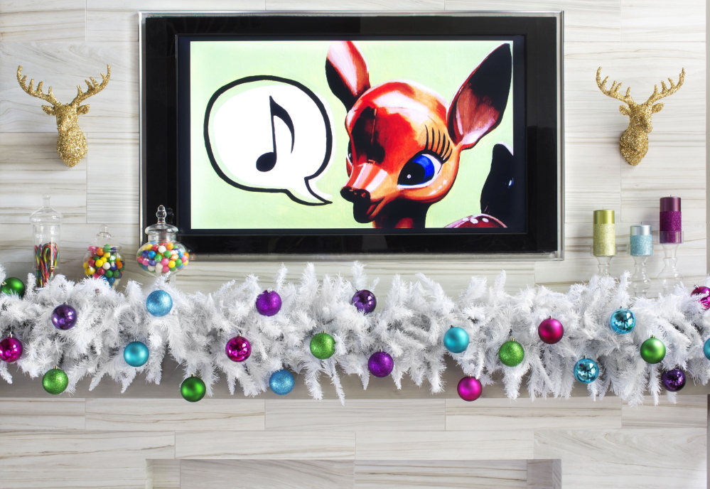 Bold colors and whimsical decorating touches around a mantel, including images copied onto a DVD and shown on a TV screen, emphasize the playful side of holiday celebrations.