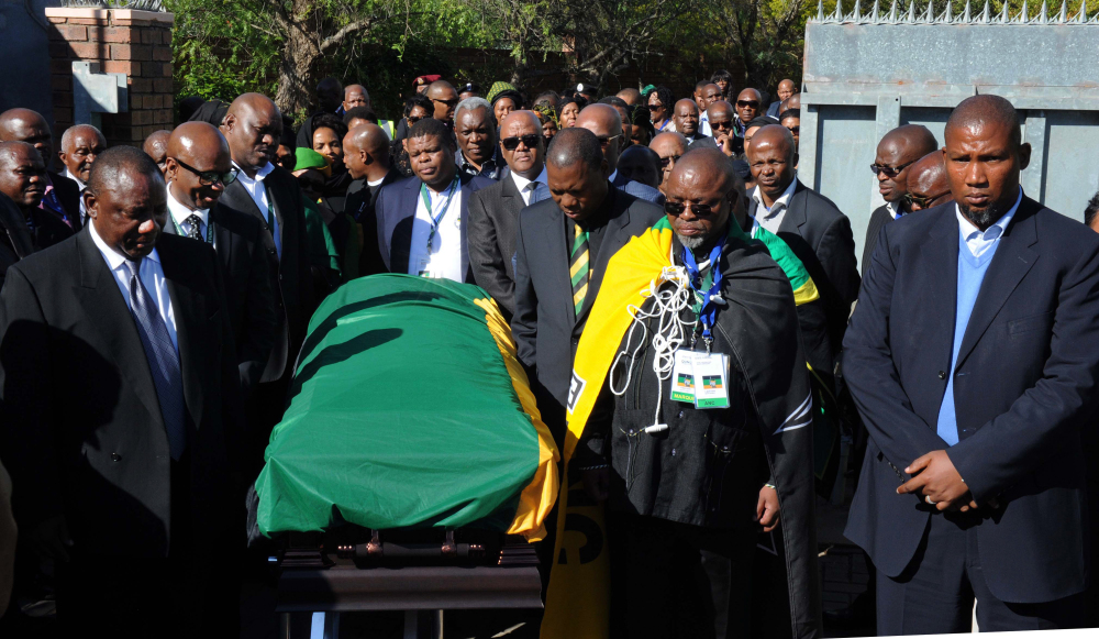 Nelson Mandela’s grandson Mandla Mandela, right, and members of the African National Congress escort the casket of former South African President Nelson Mandela as it arrives at the Mandela residence in Qunu, South Africa on Saturday. Mandela will be put to rest after funeral services on Sunday.