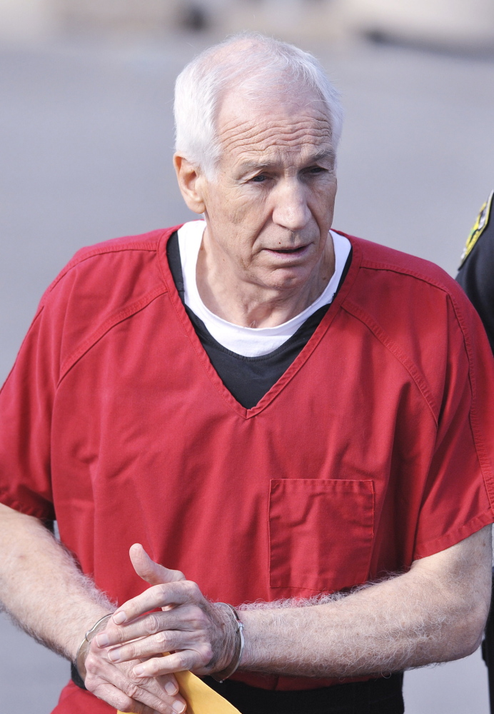 Former Penn State coach Jerry Sandusky leaves court after his sentencing in 2012.