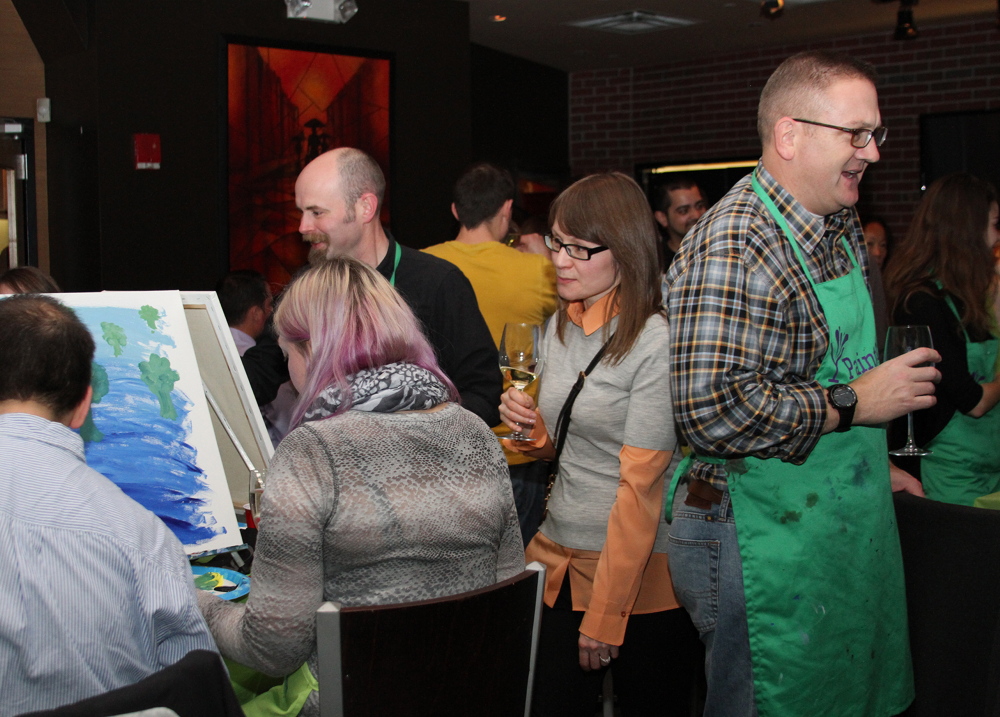 Employees from software company Lattice Engines’ Boston office participate in a Paint Nite class earlier this month. Paint Nite gives painting lessons at bars and restaurants. About 65 people attended, painting trees while they drank and ate hors d’oeuvres.