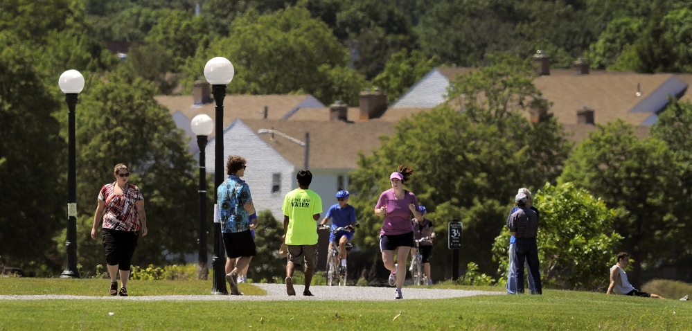 People exercise along Back Cove in Portland last summer. To help address the rate of obesity in Maine – one of the state’s major health challenges – municipalities and the Maine DOT should put more effort into including sidewalks and walk and bike paths in road projects.