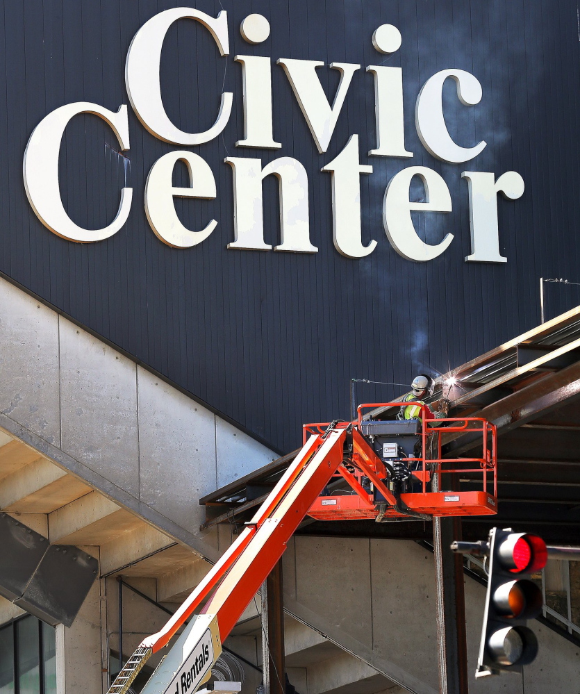 A worker welds a steel beam on the exterior of the Cumberland County Civic Center Sept. 27, a day after the Portland Pirates announced they would play all of their home games at the Androscoggin Bank Colisee in Lewiston.