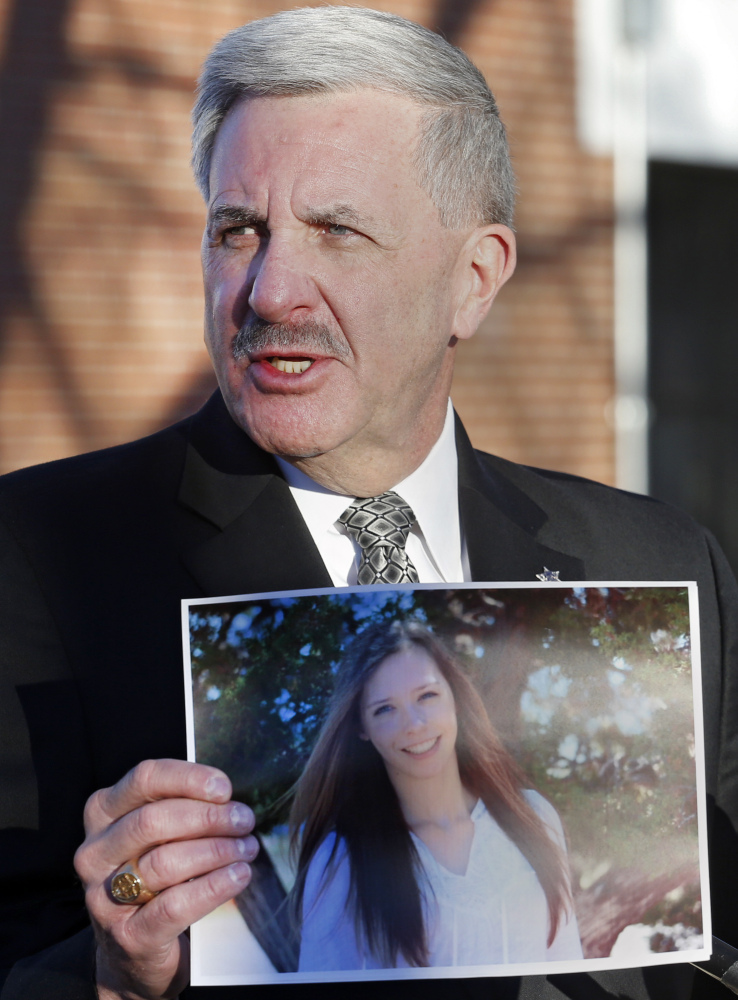 Arapahoe County Sheriff Grayson Robinson holds a picture of Claire Davis, who was shot at Arapahoe High School in Centennial, Colo., on Dec. 13. Davis died Saturday.