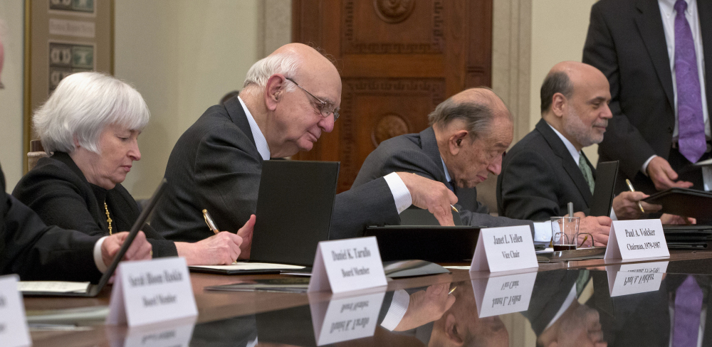 From left, Janet Yellen, President Obama’s choice to head the Federal Reserve Board, former Chairman Paul Volcker, former Chairman Alan Greenspan and outgoing Chairman Ben Bernanke participate in the ceremonial signing of a certificate commemorating the 100th anniversary of the signing of the Federal Reserve Act, at the central bank in Washington.