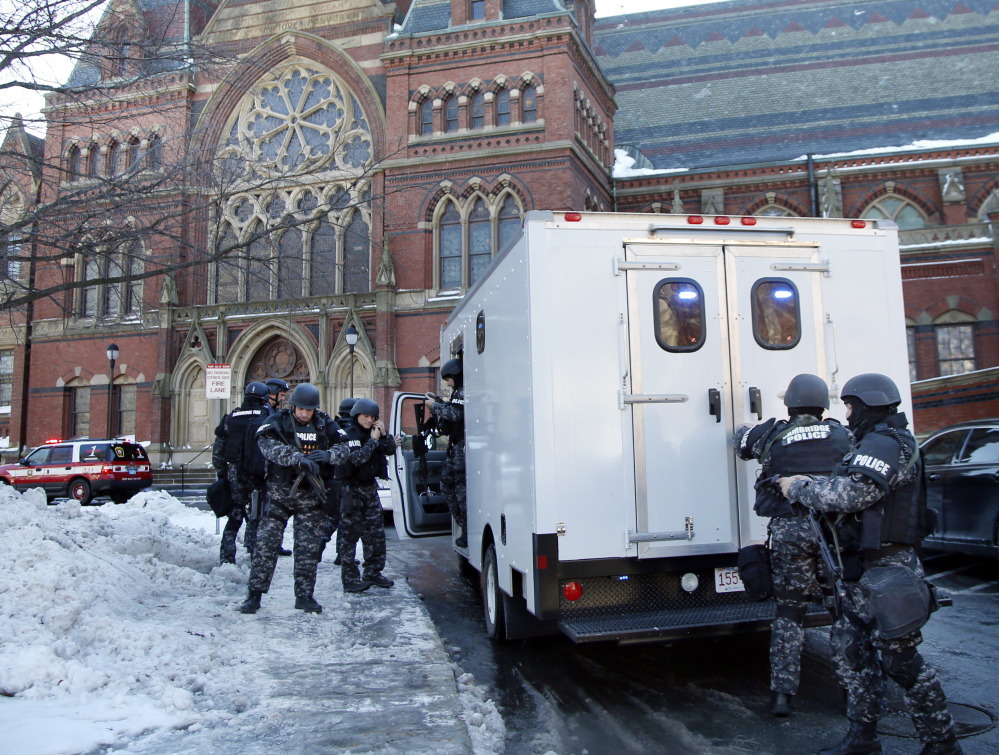 SWAT team officers arrive at a building in Harvard Yard at Harvard University in Cambridge, Mass., Monday, after campus police received an unconfirmed report that explosives may have been placed inside. No explosives were found.