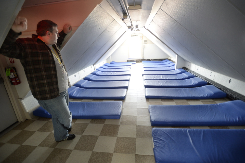 Robert Parritt, the assistant director, looks over one of the rooms at the Oxford Street Shelter that often fill up as people come in from the cold in Portland. The shelter can hold about 125 people on any given night.