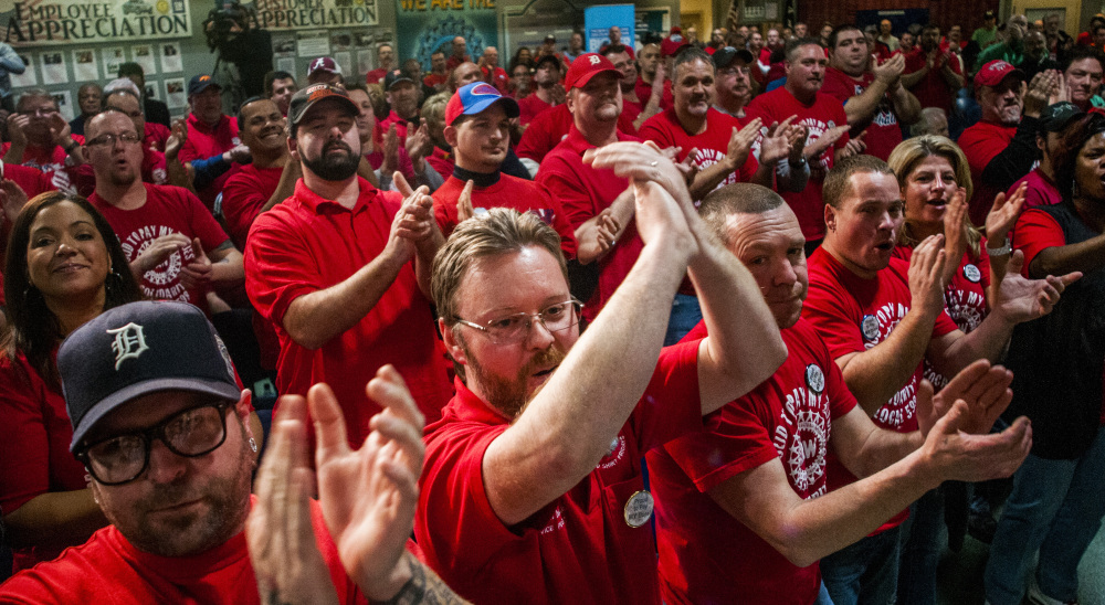 Union workers in Flint, MIch., celebrate General Motors’ announcement Monday that the company is investing $1.2 billion in several factories. The automaker is revamping its paint shop and developing the industry’s first 10-speed automatic transmission.