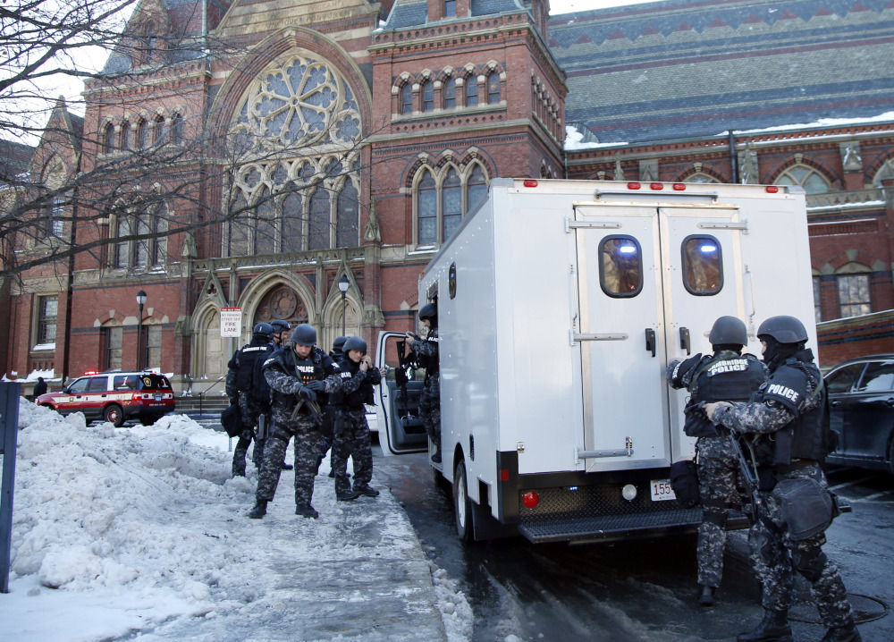 SWAT team officers arrive at a building at Harvard University in Cambridge, Mass., Monday, Dec. 16, 2013. Four buildings on campus were evacuated Monday after campus police received an unconfirmed report that explosives may have been placed inside, interrupting final exams.