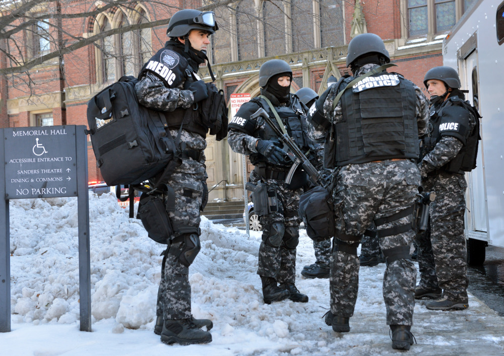 Tactical police assemble outside a building at Harvard University in Cambridge, Mass., Monday, Dec. 16, 2013. Four buildings on campus were evacuated after campus police received an unconfirmed report that explosives may have been placed inside, interrupting final exams.
