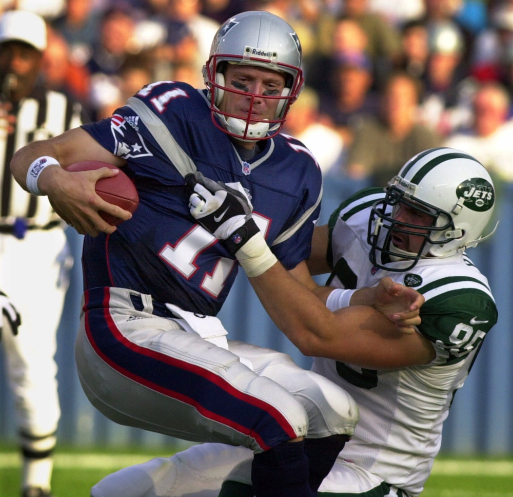 New England Patriots quarterback Drew Bledsoe (11) is sacked by New York Jets defensive end Rick Lyle (95) during first half of NFL action at Foxboro Stadium in Foxboro, Mass. on Oct. 15, 2000.