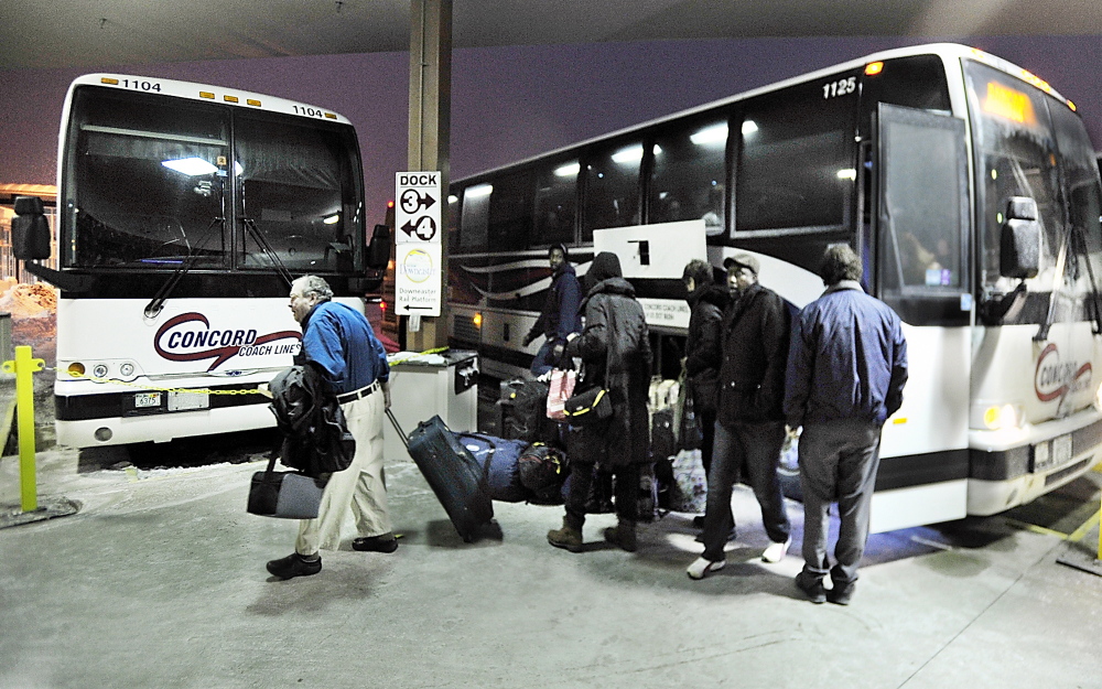Passengers exit a Concord Coach Lines bus arriving Monday at the Portland Transportation Center. The bus line is looking into starting service from Auburn to Boston with a stop in Wells.