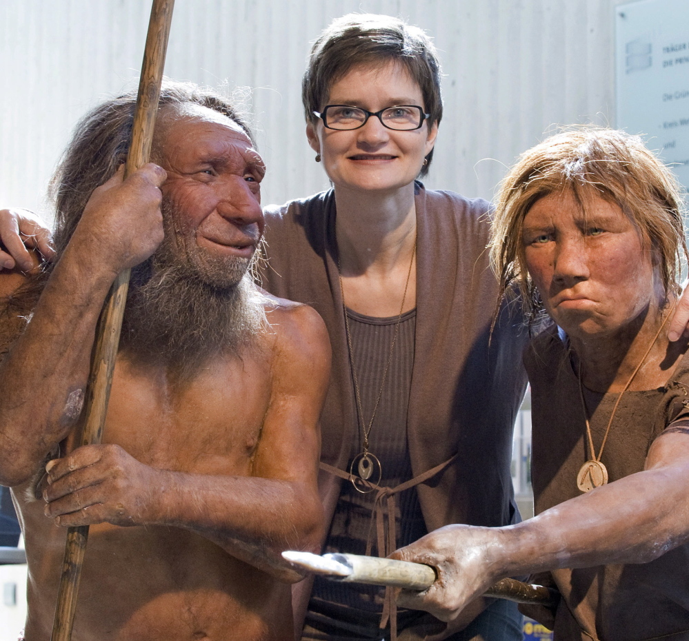 Baerbel Auffenmann, deputy museum director, poses with models of Neanderthals at the Neanderthal Museum in Mettmann, Germany, in 2009. DNA from an ancient toe bone suggests that Neanderthals mated with close relatives and with members of other hominid groups.
