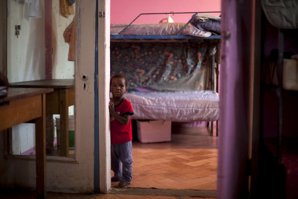 A young boy stands in his room in the U.S.-based Church of Bible Understanding orphanage in Kenscoff, Haiti.