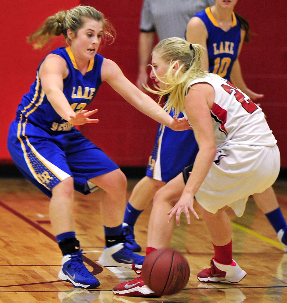 Sarah Hancock of Lake Region left, attempts to hold her ground while defending against Alison Furness of Wells.