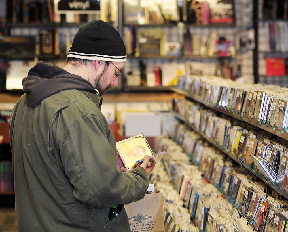 Brady Alden of Gray shops for CDs at Bull Moose in Portland. He likes to wander into local stores, he said, because “I think you find better stuff – things you weren’t even looking for that catch your eye.”