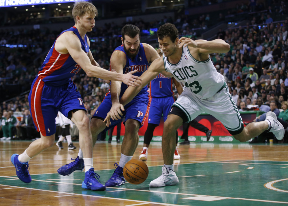 Celtics power forward Kris Humphries, right, goes for a loose ball against Pistons forwards Kyle Singler, left, and Josh Harrellson during the second half of Detroit’s 107-106 win at Boston on Wednesday night.