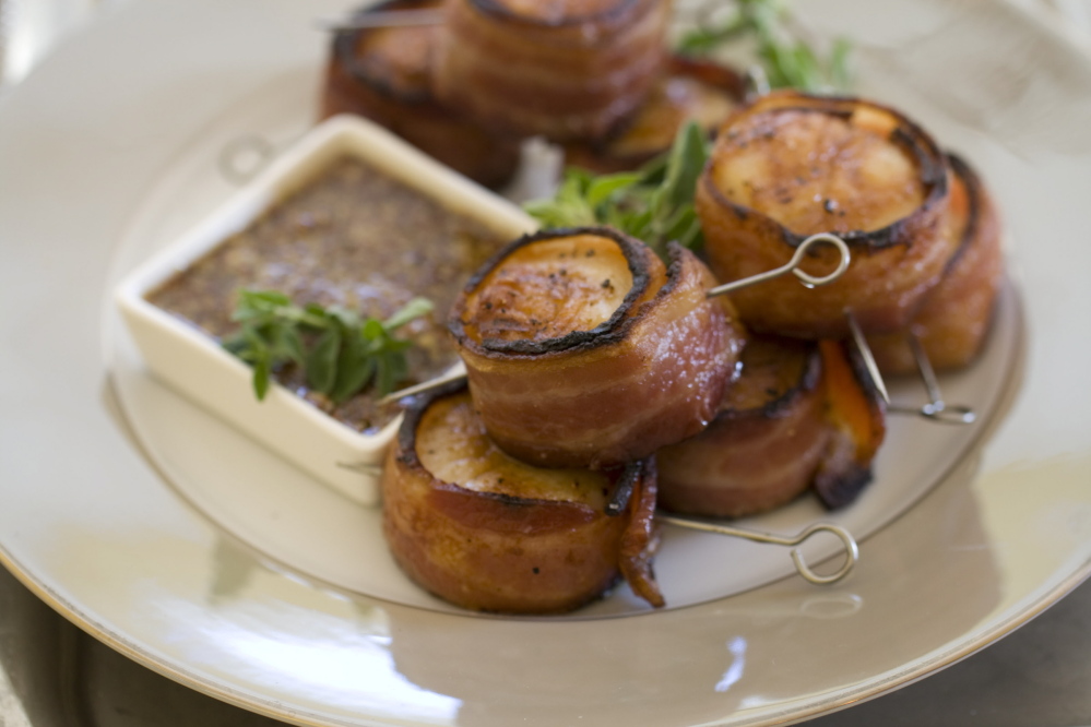 This Nov 4, 2013 photo shows grilled bacon wrapped scallops in Concord, N.H. This all-protein finger food appetizer is perfect for holiday entertaining.