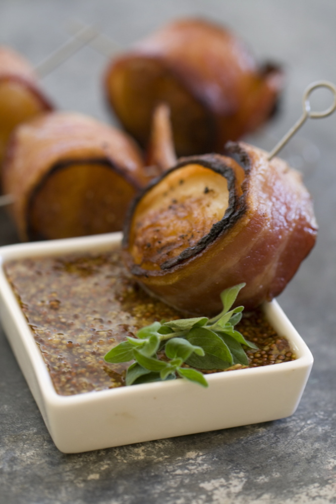 This Nov 4, 2013 photo shows grilled bacon wrapped scallops in Concord, N.H. This all-protein finger food appetizer is perfect for holiday entertaining.