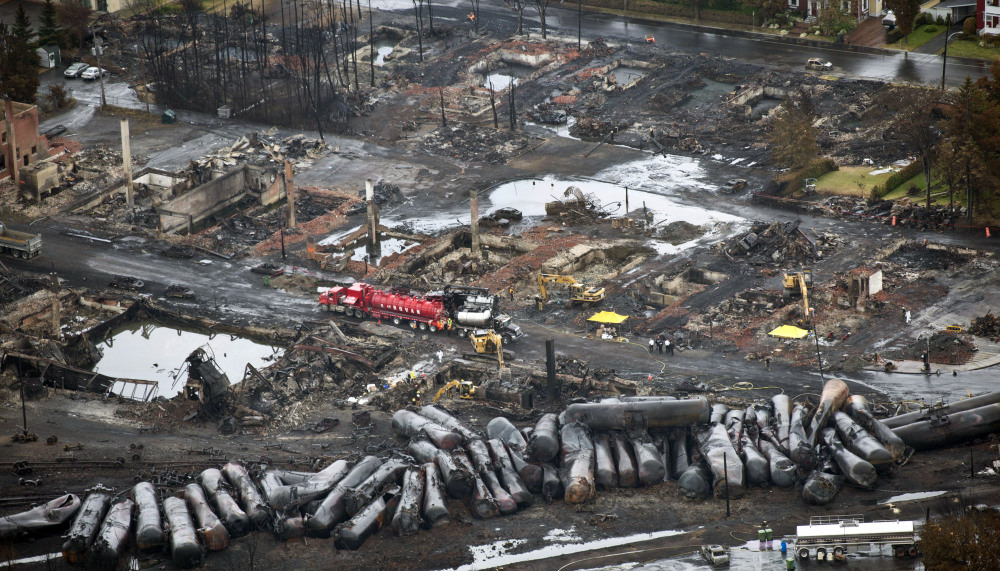 Workers comb through debris in Lac-Megantic, Quebec, on July 9, three days after an unmanned train with 72 railway cars carrying crude oil derailed, causing explosions that killed 47 people. The Canadian town is 10 miles from Maine’s northwestern border.