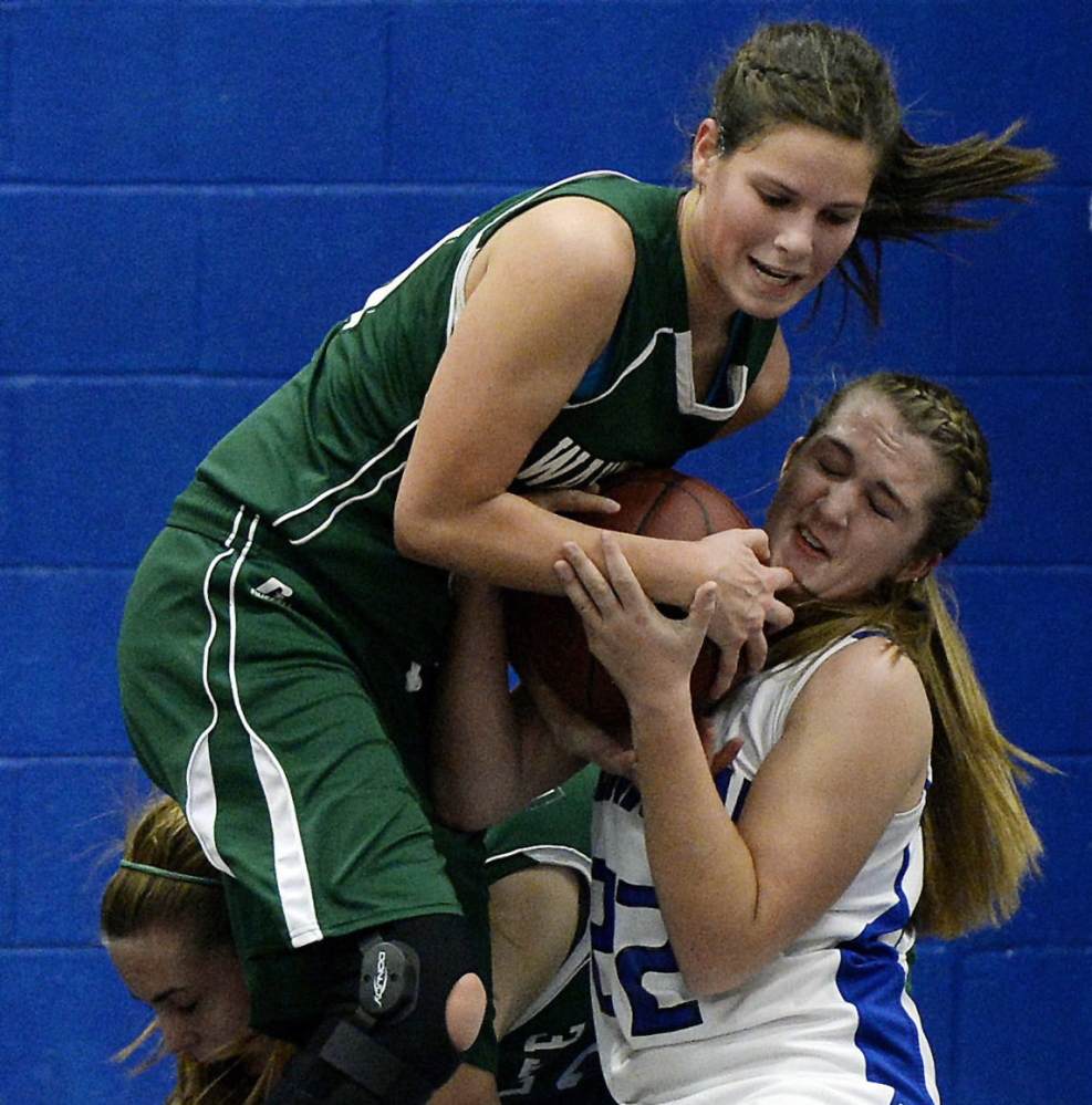 Juliana Harwood, left, of Waynflete and Lauralee Small of Old Orchard Beach battle for the ball during Waynflete’s 46-44 win Thursday night.
