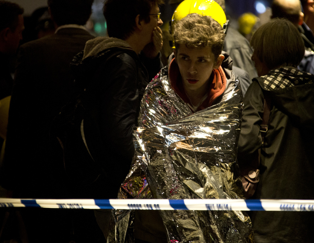 A man wraps himself in an emergency foil blanket provided by rescue services following an incident at the Apollo Theatre, in London’s Shaftesbury Avenue, Thursday evening, Dec. 19, 2013 during a performance , with police saying there were “a number” of casualties. It wasn’t immediately clear if the roof, ceiling or balcony had collapsed. The London Fire Brigade said the theatre was almost full, with around 700 people watching the performance. A spokesman added: “It’s thought between 20 and 40 people were injured.”