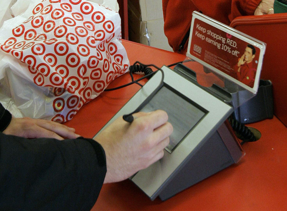 A customer signs his credit card receipt at a Target store in Tallahassee, Fla. Target says that about 40 million credit and debit card accounts customers may have been affected by a data breach that occurred at its U.S. stores between Nov. 27, 2013, and Dec. 15, 2013.
