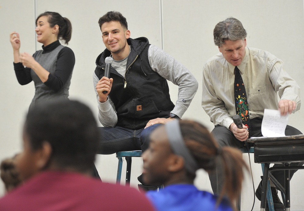 Portland native Ryan Flaherty of the Baltimore Orioles, center, answers questions from the students along with the school’s principal, Stephen Rogers, right, on Thursday.