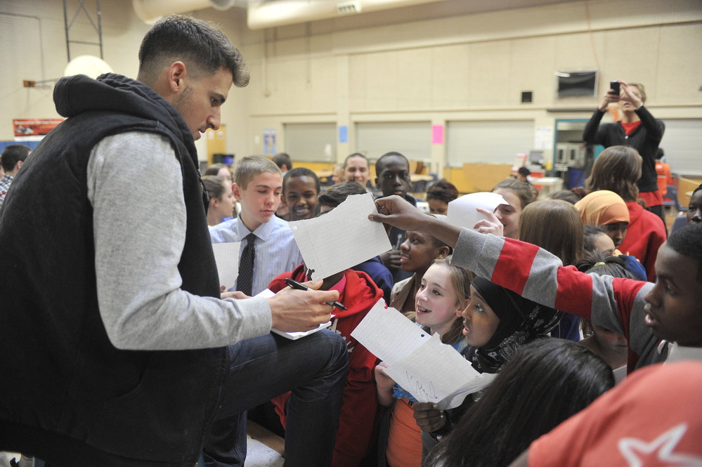 Portland native Ryan Flaherty of the Baltimore Orioles signs autographs for students at Lyman Moore Middle School after talking about his baseball career Thursday.