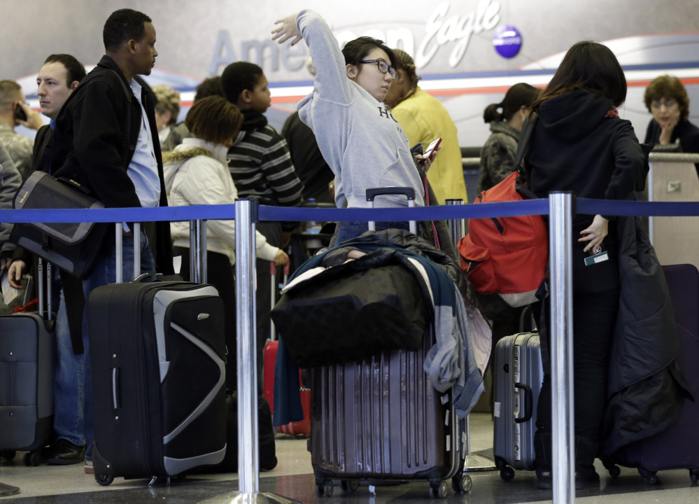 Passengers line up at ticket counters inside Terminal 3 at O’Hare International Airport in Chicago on Friday. Chicago was among three airports dealing with most of Friday’s delayed flights.