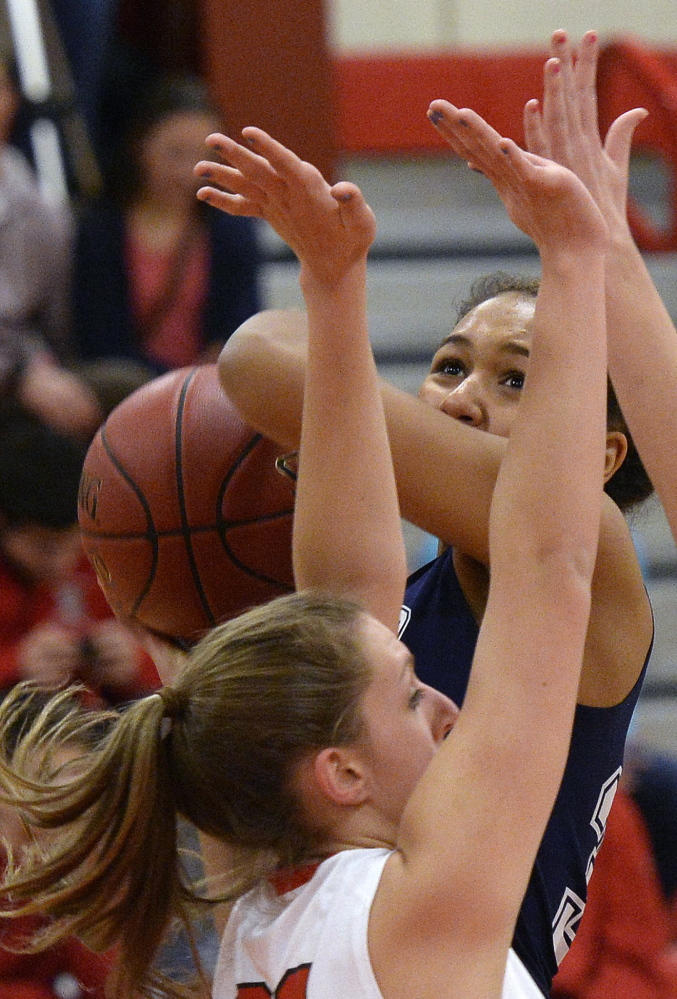 Gabrielle Wagabaza of Portland drives to the basket against South Portland’s MacKenzie Bowring during their SMAA basketball game Friday night. Portland won, 50-46.
