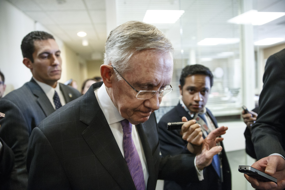 Senate Majority Leader Harry Reid is surrounded by reporters after talking about the final work of the Senate as the legislative year nears to a close, at the Capitol on Thursday.
