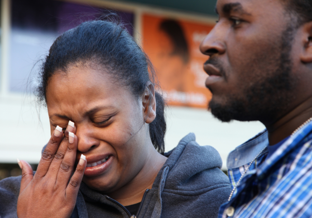 Nailah Winkfield, mother of 13-year-old Jahi McMath, wipes her face while speaking to reporters with her husband, Martin Winkfield, on Monday at Children’s Hospital Oakland in Oakland, Calif. Jahi McMath remains on life support after undergoing a tonsillectomy.