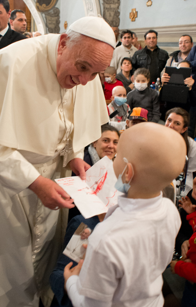 Pope Francis speaks with a child during his visit to the Bambino Gesu’ pediatric hospital in Rome on Saturday. He continues revamping the Vatican administration.