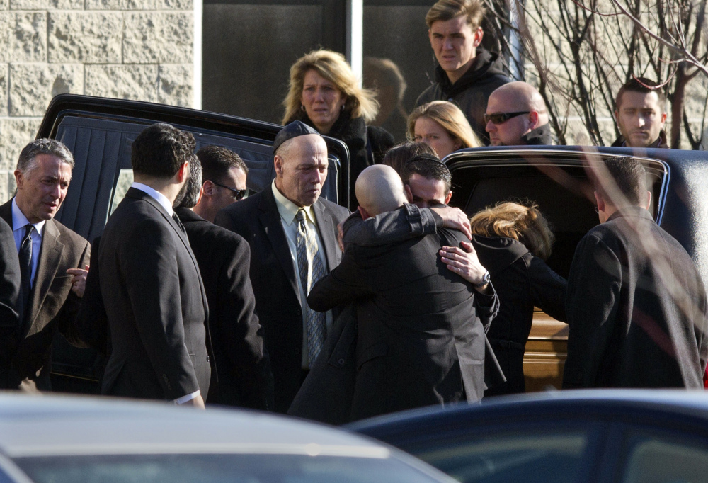 Mourners grieve outside the temple after the funeral service for Daniel Friedland Wednesday in Lakewood, N.J. Friends and relatives gathered to mourn the 30-year-old lawyer who was shot to death by a carjackers outside a northern New Jersey mall last weekend.