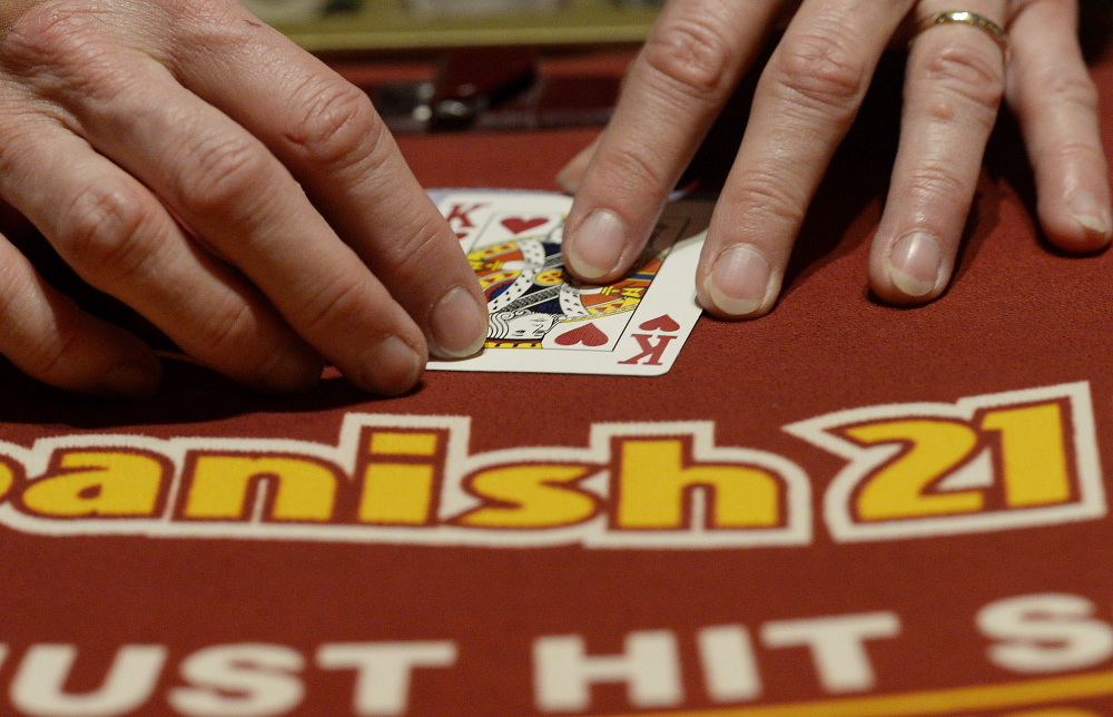 A dealer flips cards at the Spanish 21 Blackjack table at Oxford Casino on Tuesday.