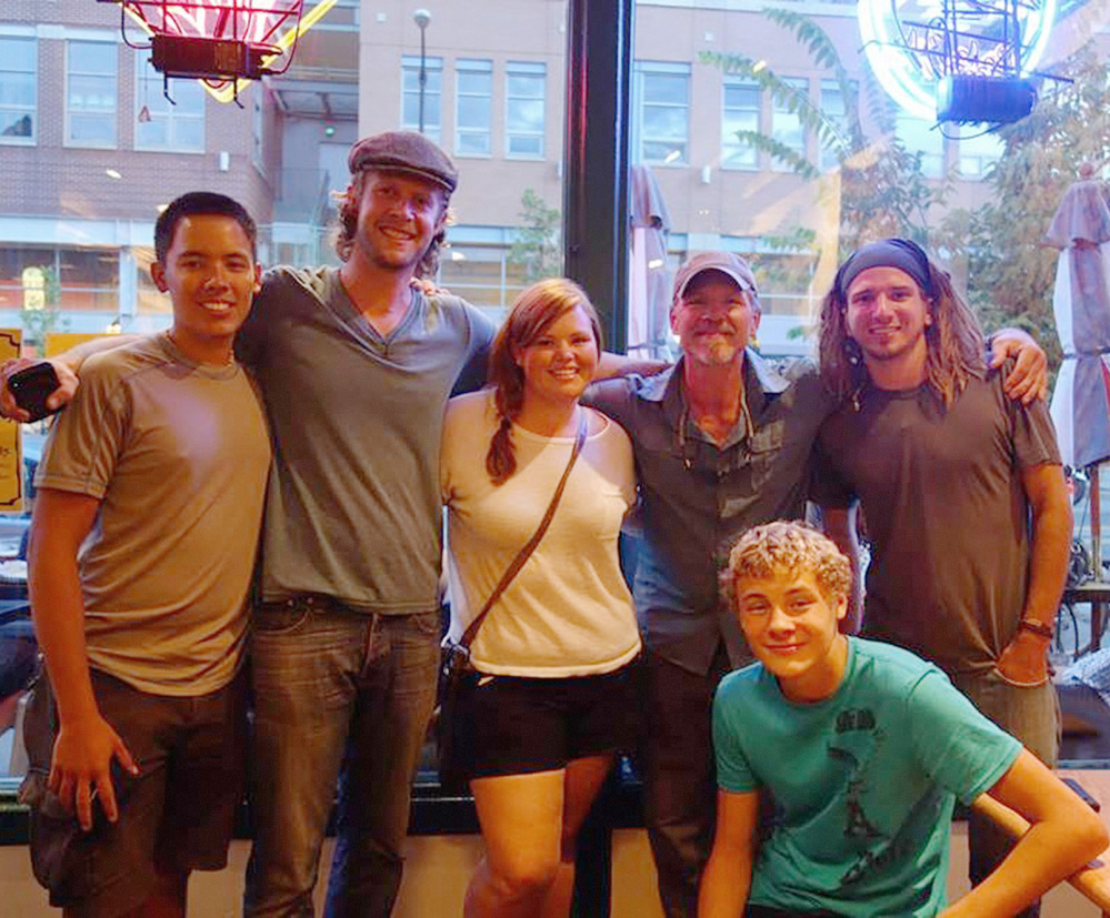 Transcontinental walkers, from left, Benjamin Lee, Jonathon Stalls, Lacey Champion, Joe Bell, Nate Damm, and kneeling, Bell’s son Joseph, gather in Boulder, Colo., last August. At any given time, as many as 20 people are attempting to cross the United States on foot, Damm estimates.