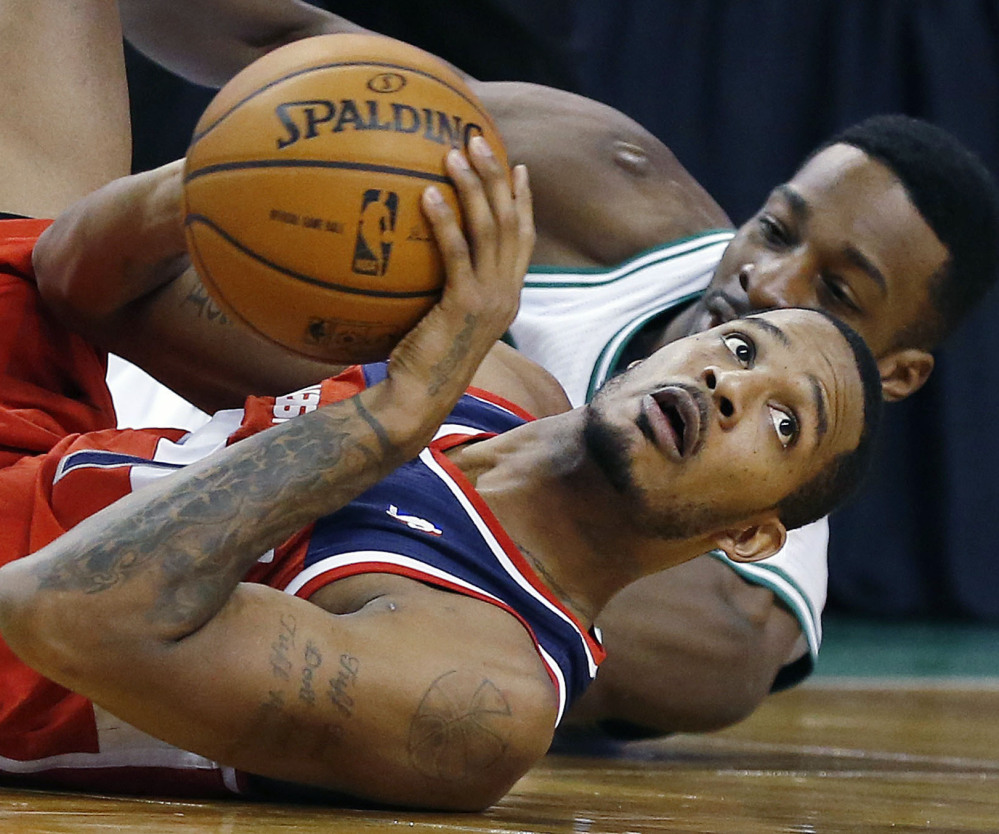 Trevor Ariza of the Washington Wizards looks to the referee after competing with Jeff Green of the Boston Celtics for the ball in the fourth quarter at Boston.