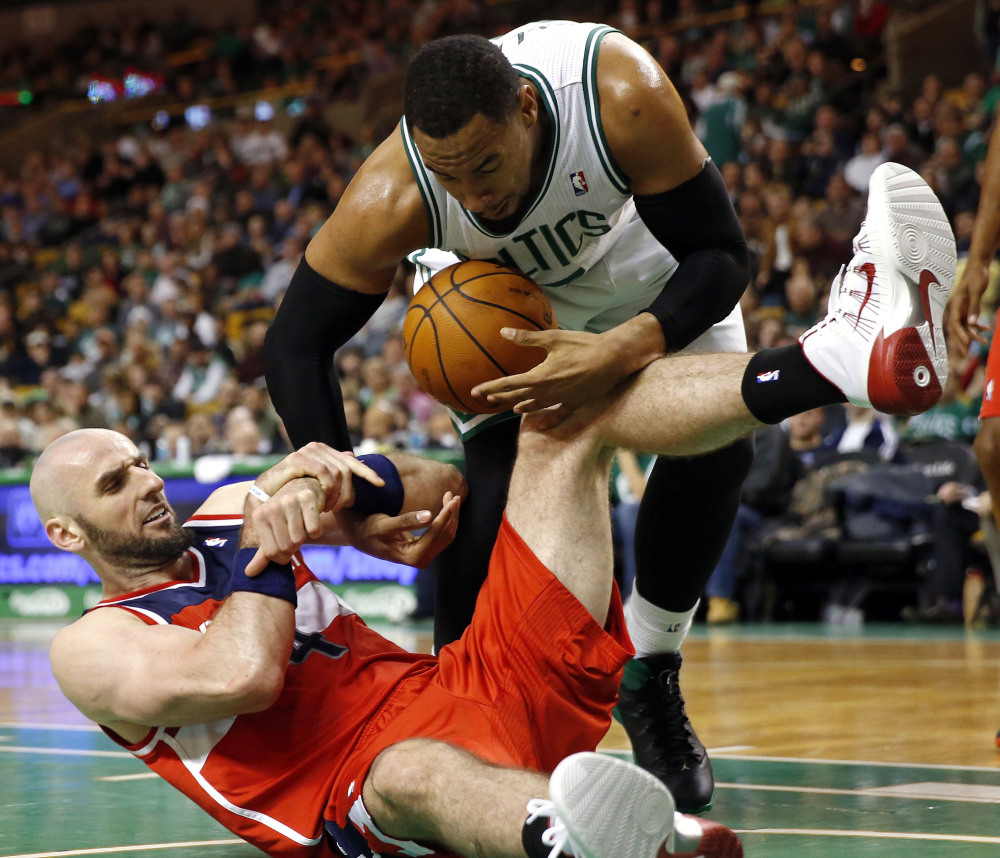 Jared Sullinger of the Boston Celtics, top, attempts to keep the ball away from Marcin Gortat of the Washington Wizards in the third quarter Saturday at Boston. The Wizards came back late for a 106-99 victory.