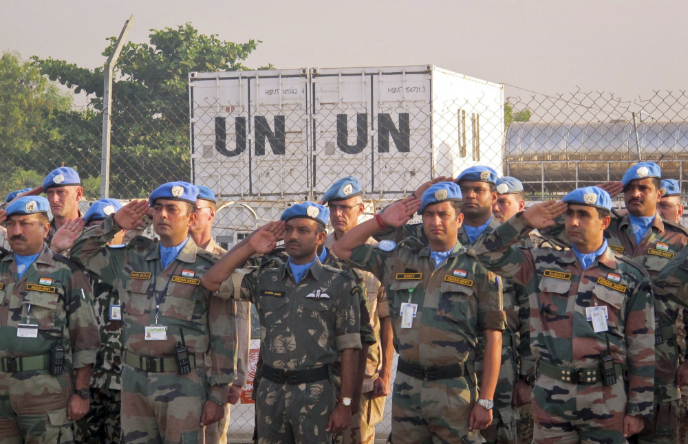 U.N. peacekeepers salute during a memorial service for their two colleagues who were killed Thursday, in the UNMISS compound in Juba, South Sudan Saturday. The U.N. peacekeeping mission strongly condemned the unprovoked attack on a U.N. base in Akobo in Jonglei state, near the Ethiopian border, on Thursday that killed two Indian peacekeepers and injured a third.