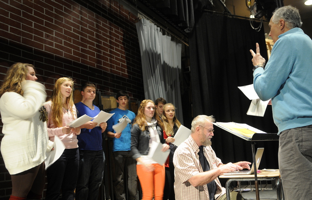 Larry Morissette, right, directs choral students at Hall-Dale High School in Farmingdale as Stan Keach, center, of Rome records the group singing his songs.