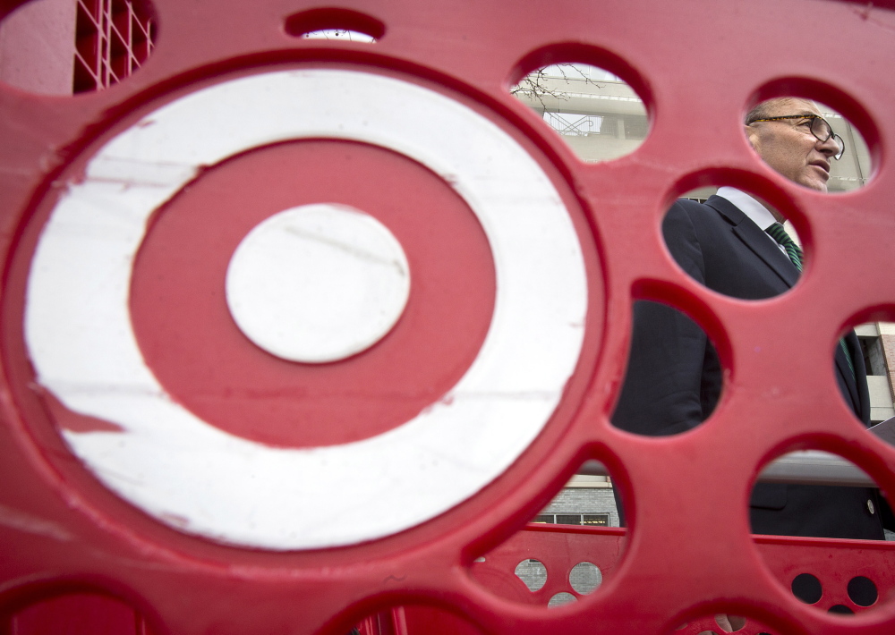 U.S. Sen. Charles Schumer, D-N.Y., pictured through a Target shopping cart, holds a news conference in New York on Sunday about the massive credit card hack that has affected 40 million Target customers.