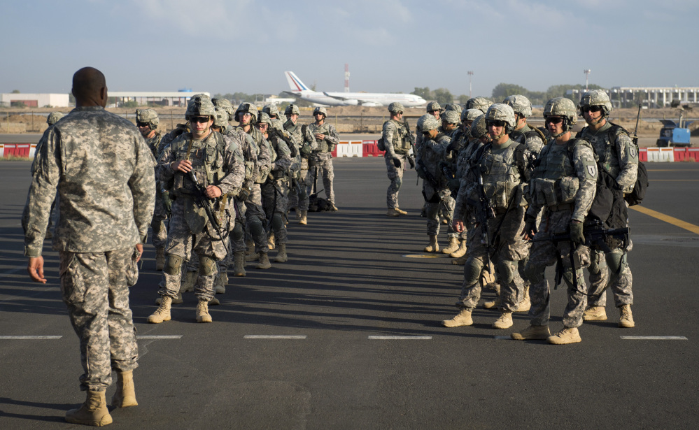 In this photo taken Wednesday, Dec. 18, 2013 and released by the U.S. Air Force, soldiers of the East Africa Response Force (EARF), a Djibouti-based joint team assigned to Combined Joint Task Force-Horn of Africa, prepare to load onto a U.S. Air Force C-130 Hercules at Camp Lemonnier, Djibouti, to support with an ordered departure of personnel from Juba, South Sudan. Gunfire hit three U.S. military CV-22 Osprey aircraft Saturday, Dec. 21, 2013 trying to evacuate American citizens in Bor, the capital of the remote region of Jonglei state in South Sudan, that on Saturday became a battle ground between South Sudan’s military and renegade troops, officials said, with four U.S. service members wounded in the attack.