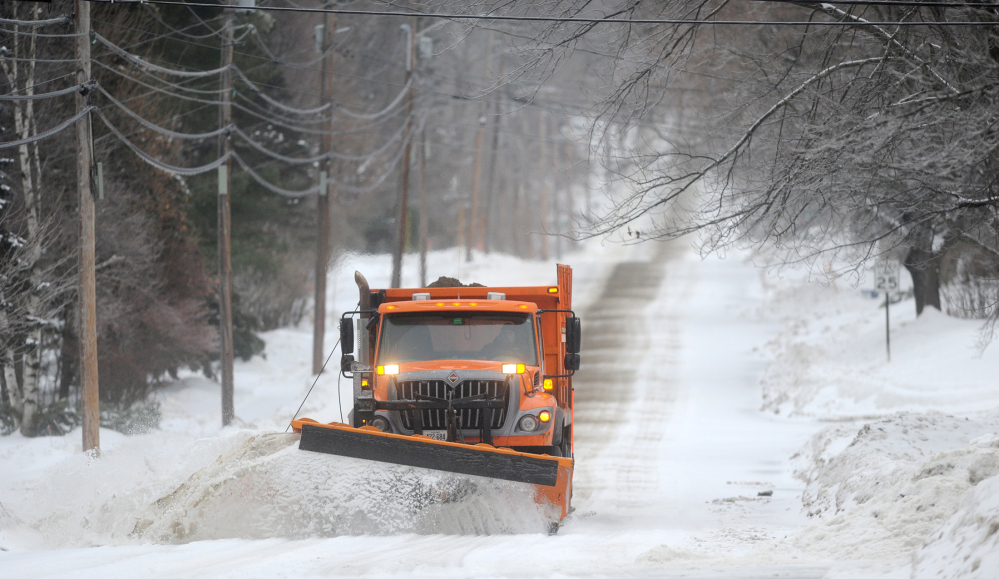 A Waterville Public Works snowplow clears Mayflower Hill Drive on Sunday morning.