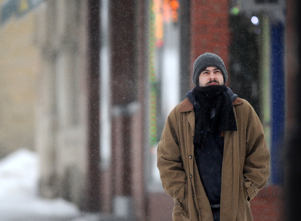 ICEY DICEY: Ray Pelkey, 27, of Waterville, wanders the streets during Sunday morning’s storm.