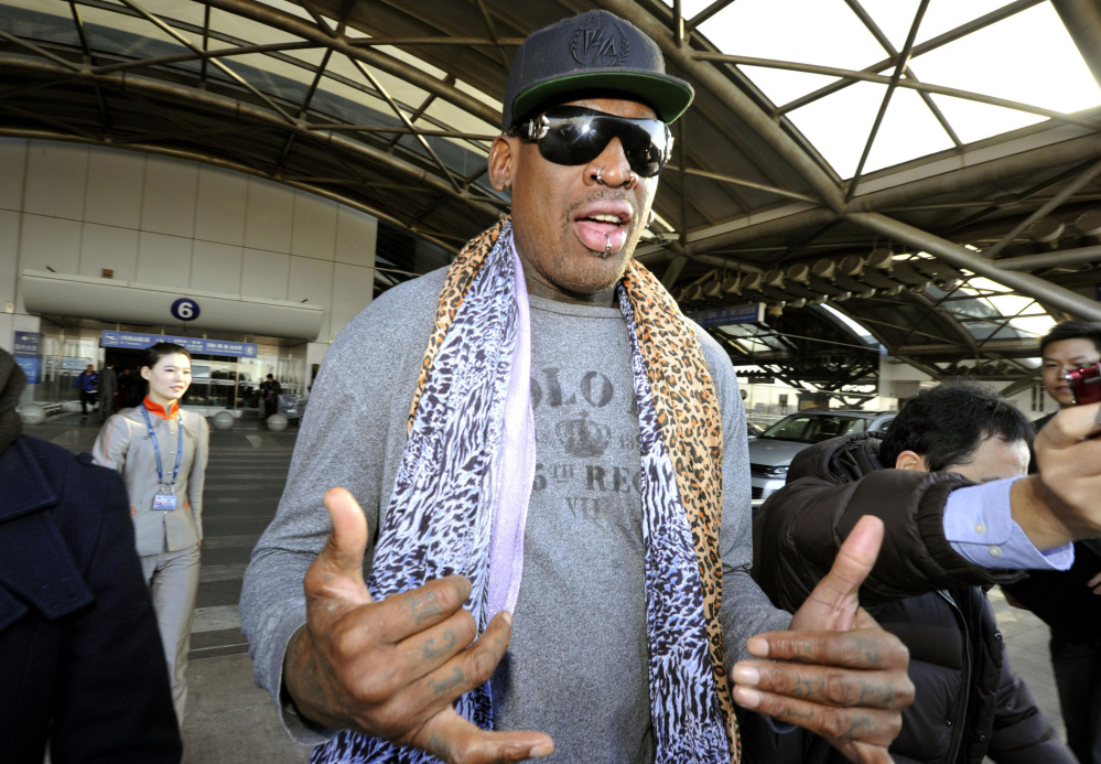 Former basketball star Dennis Rodman speaks to journalists upon arrival at the capital airport in Beijing from Pyongyang, North Korea, on Monday.